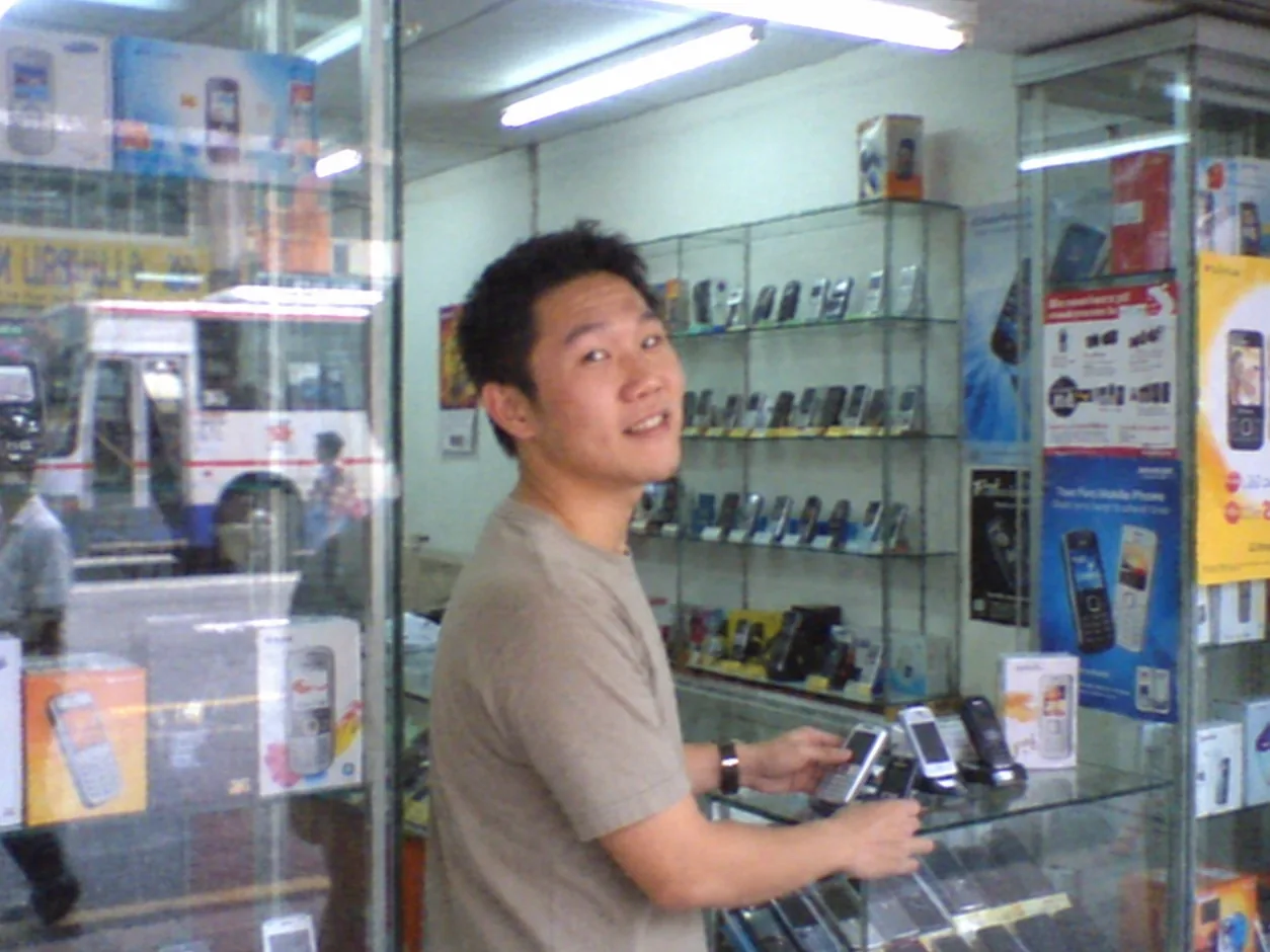 Young Aaron Chong selling mobile phones in a phone shop